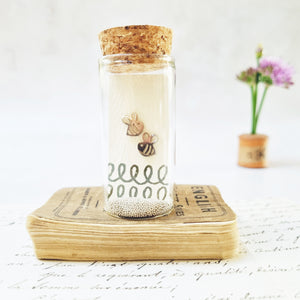 Bold bee stud earrings in a bottle