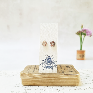 Classic daisy flower stud earrings in a bottle