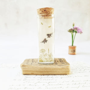 Classic bird on flower stem stud earrings in a bottle