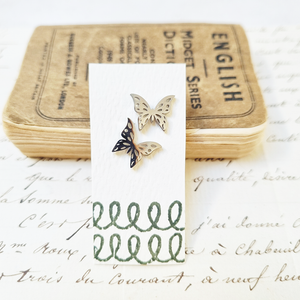 Intricate Butterfly Stud Earrings in a bottle