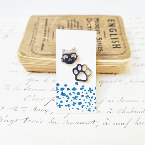 Cute cat and paw stud earrings in a bottle