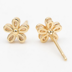 Gold flower stud earrings in a bottle