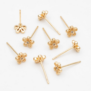 Gold daisy flower stud earrings in a bottle