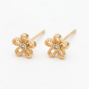 Gold daisy flower stud earrings in a bottle