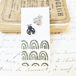 Bold ladybird stud earrings in a bottle