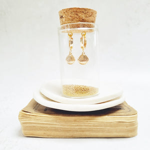 Gold Shell Huggie Earrings in a bottle