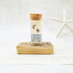 Smiley star and moon stud earrings in a bottle