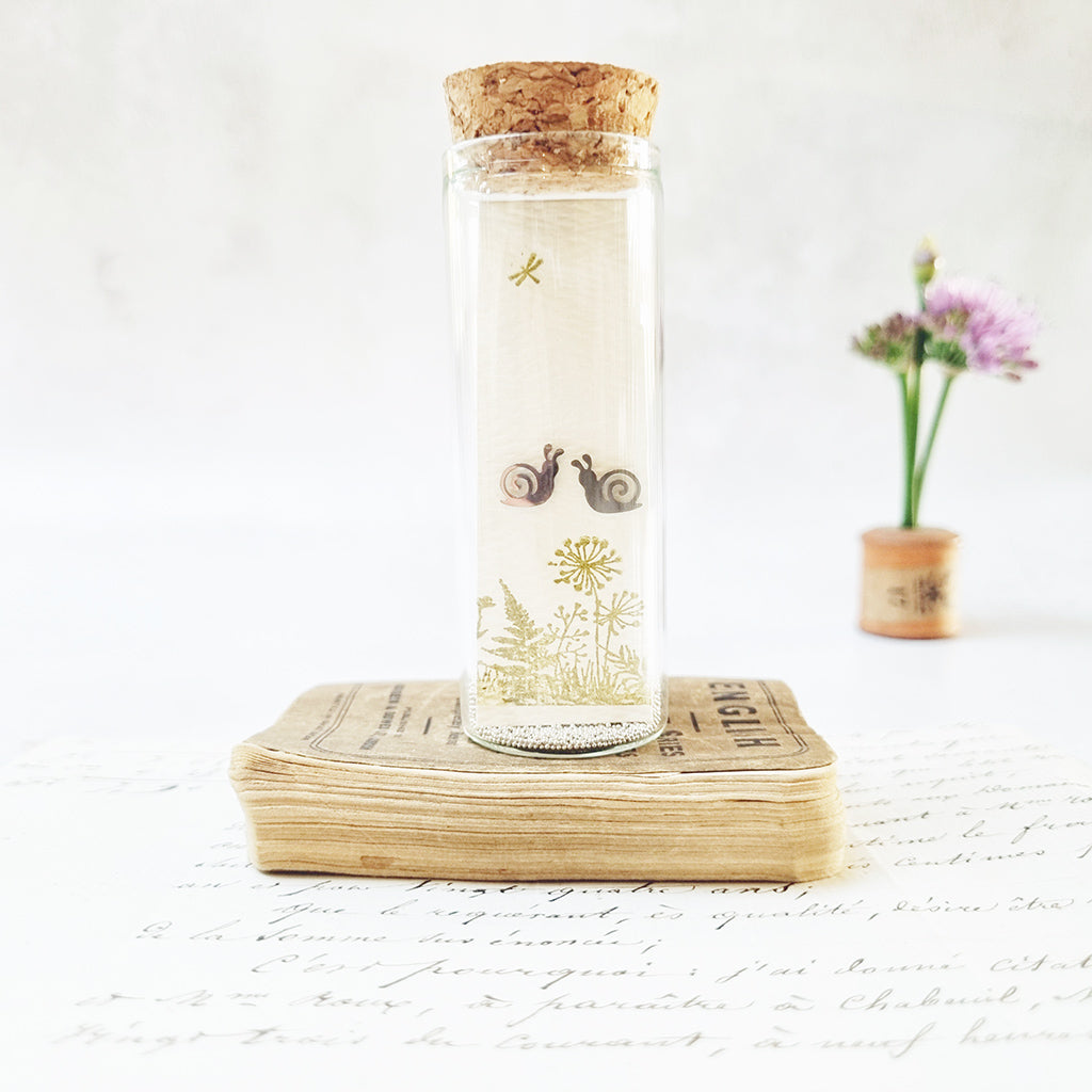 Gardeners snail stud earrings in a bottle